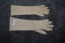 A pair of vintage beige Christian Dior sea island gloves.