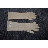 A pair of vintage beige Christian Dior sea island gloves.