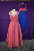 Two vintage 1950s dresses, one full length gown and another of blue and pink satin by Ricci