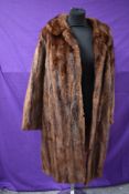 A vintage late 1950s/60s mahogany mink coat with pockets to front, fully lined,medium size approx.