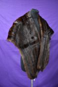 A dark brown mink stole having capstick and Hamer,Bradford and Morecambe label.