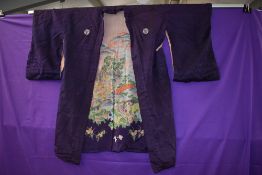 A reversible mid 1940s silk kimono having purple silk to one side and pale pink with oriental