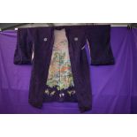 A reversible mid 1940s silk kimono having purple silk to one side and pale pink with oriental