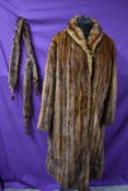 A vintage brown mink coat and tippet with feet and tales.