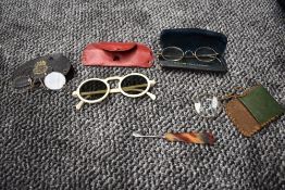 A pair of 1930s/1940s sunglasses, a pair of antique wire framed specs, a eye glass in case and pince