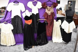 A collection of 70s and 80s statement evening dresses amongst which is a full length black acetate