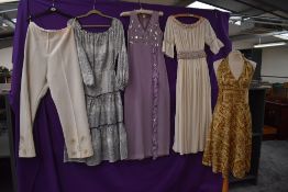 A collection of vintage 60s and 70s clothing, including sequinned maxi dress.