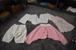 Four pairs of antique bloomers including pink wool based pair, also included is a pale pink half