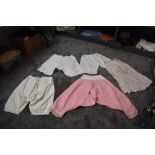 Four pairs of antique bloomers including pink wool based pair, also included is a pale pink half