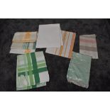 A variety vintage of table cloths including damask, some still in packaging.