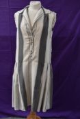 A cream and grey striped silk 1920s day dress having self covered buttons to front with pleats to