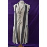 A cream and grey striped silk 1920s day dress having self covered buttons to front with pleats to