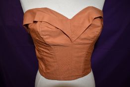 A 1950s russet coloured 'florelle Paris' boned sun top, size label of 32.