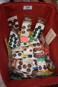 A basket containing around fifty cards of vintage buttons, various styles,colours and sizes.