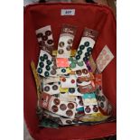 A basket containing around fifty cards of vintage buttons, various styles,colours and sizes.