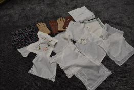 A pair of pig skin driving gloves, a similar synthetic pair and a collection of handkerchiefs.