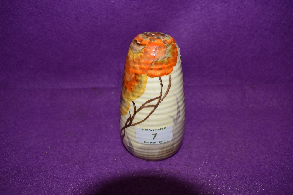 An art deco sugar sifter by Clarice Cliff Newport pottery decorated with traditional landscape and