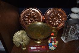 A selection of brass and copper items including footed chase worked dish and jelly or similar molds