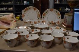 Around forty two pieces of vintage court china having a hand tinted floral transfer pattern and gilt