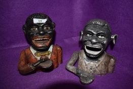 Two mechanical cast money boxes one being genuine vintage and similar modern cast version