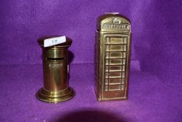 Two brass cast money savings or penny banks one designed as a phone box