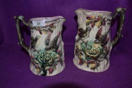 Two traditional Majollica styled Victorian water jugs having pressed and decorated bodys both jugs