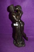 A modern resin cast sculpture of two lovers embracing by Heredities