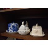 A selection of kitchen wares including lidded cheese dome and hen styled egg nest