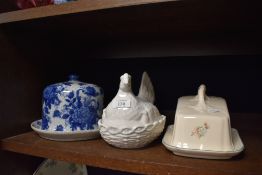 A selection of kitchen wares including lidded cheese dome and hen styled egg nest