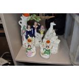 A selection of Staffordshire flatback figures including girl with dogs and spill vase pair