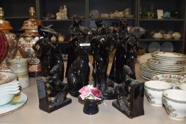 A selection of black glazed ceramic figurines and figures including cat and horse book ends