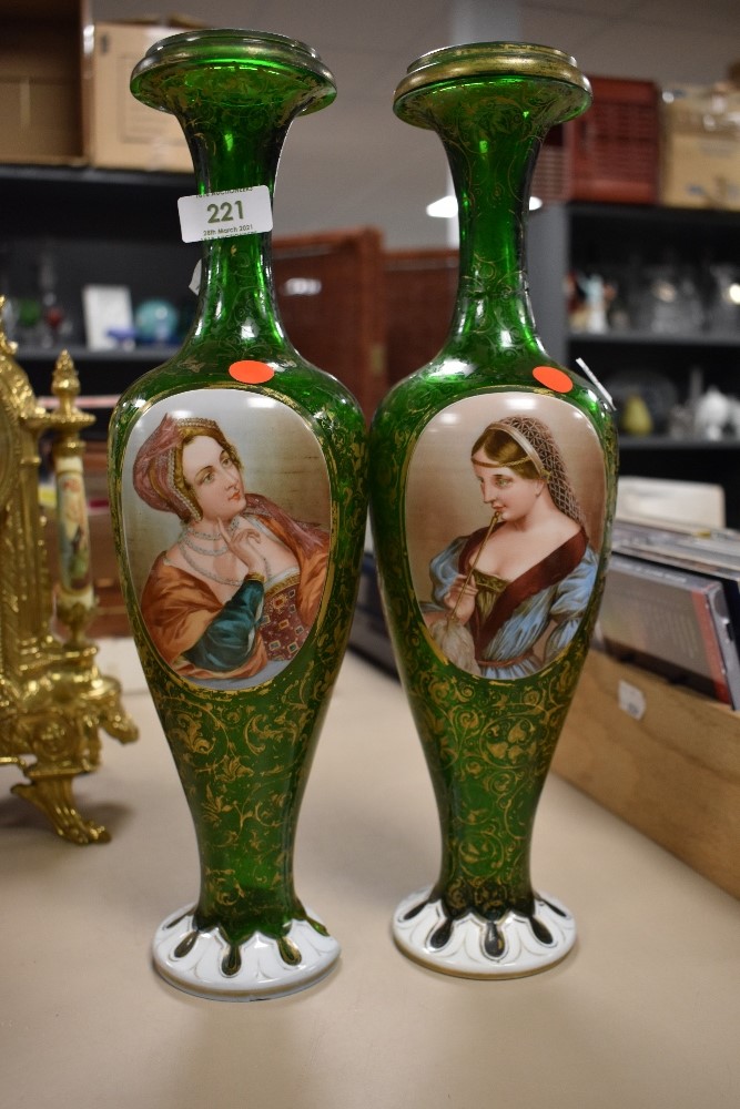 A pair of Victorian Venician style green glass vases having extensively detailed hand painted