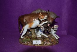 A German porcelain figure base of a Bison and dog hunting scene bearing Meissen crossed swords