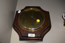 An Edwardian shield design barometer having chased brass facedial