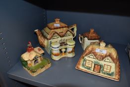 A collection of hand painted country cottage ceramics including tea pot, cheese dome, lidded sugar