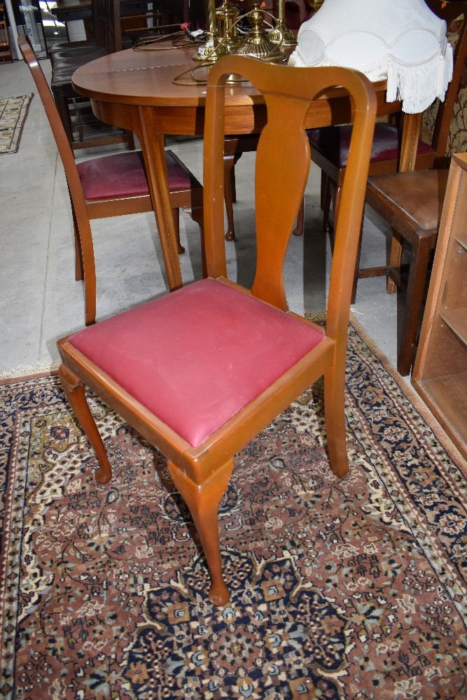 A set of four early 20th Century stained frame dining chairs and an oak rail back dining chair