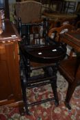 A Victorian stained frame high/low chair on turned frame with wheel