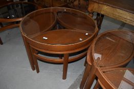 A interesting vintage glass top coffee table , nesting three occasional tables