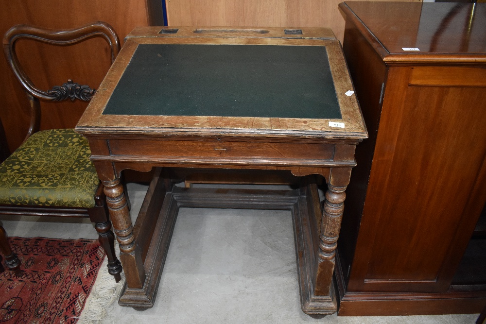 A late 19th or early 20th Century traditional oak clerks desk of large proportions, hinges present