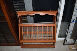 A modern stained pine plate rack, approx width 74cm