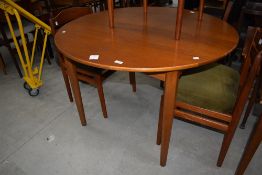 A vintage part teak dining table, possibly Danish, diameter approx 108cm with 38cm centre leaf