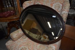 An early 20th Century oak frame oval wall mirror, width approx. 83cm