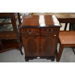 A reproduction Regency style mahogany and inlay enclosed hifi cabinet/cupboard, having serpentine