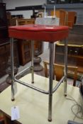 A vintage chrome frame kitchen stool with party vinyl seat