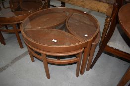 A interesting vintage glass top coffee table , nesting three occasional tables