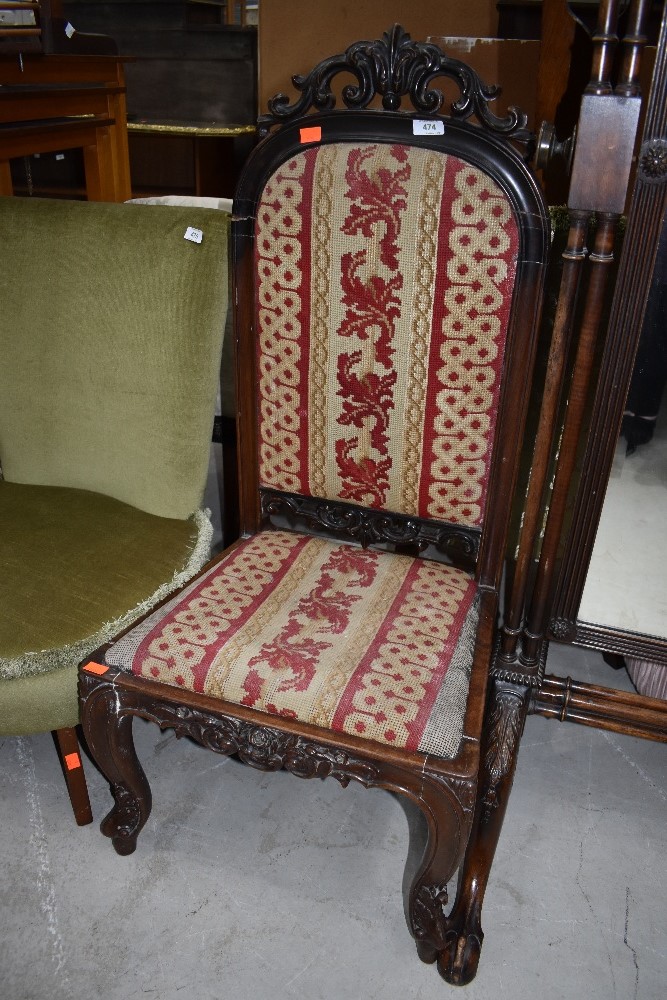 A Victorian low seat hall or nursing chair having tapestry style seat and back