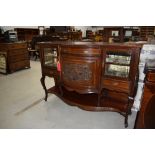 A Victorian mahogany chiffoneir base having demi bow front with carved applique panel, flanked by