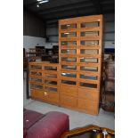 Two sets of vintage shop/merchants drawers, having glass fronts, with deeper lower drawers, taller