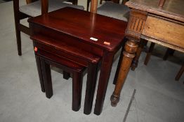 A modern rosewood effect nest of three tables
