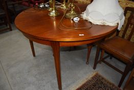 A vintage teak effect circular extending dining table, diameter approx. 122cm